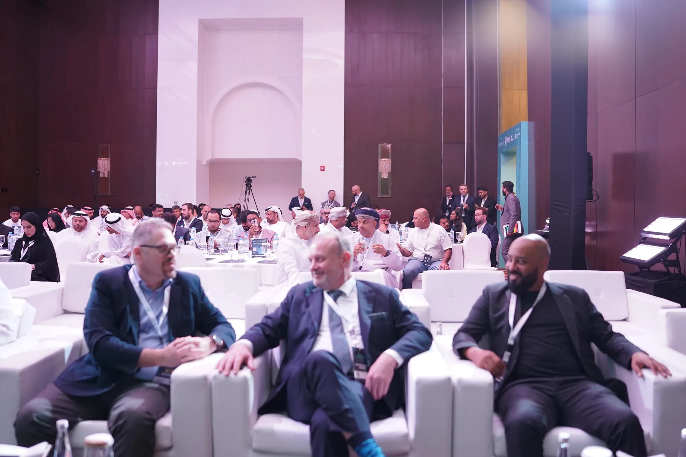 Delegates seated in the audience at a conference session
