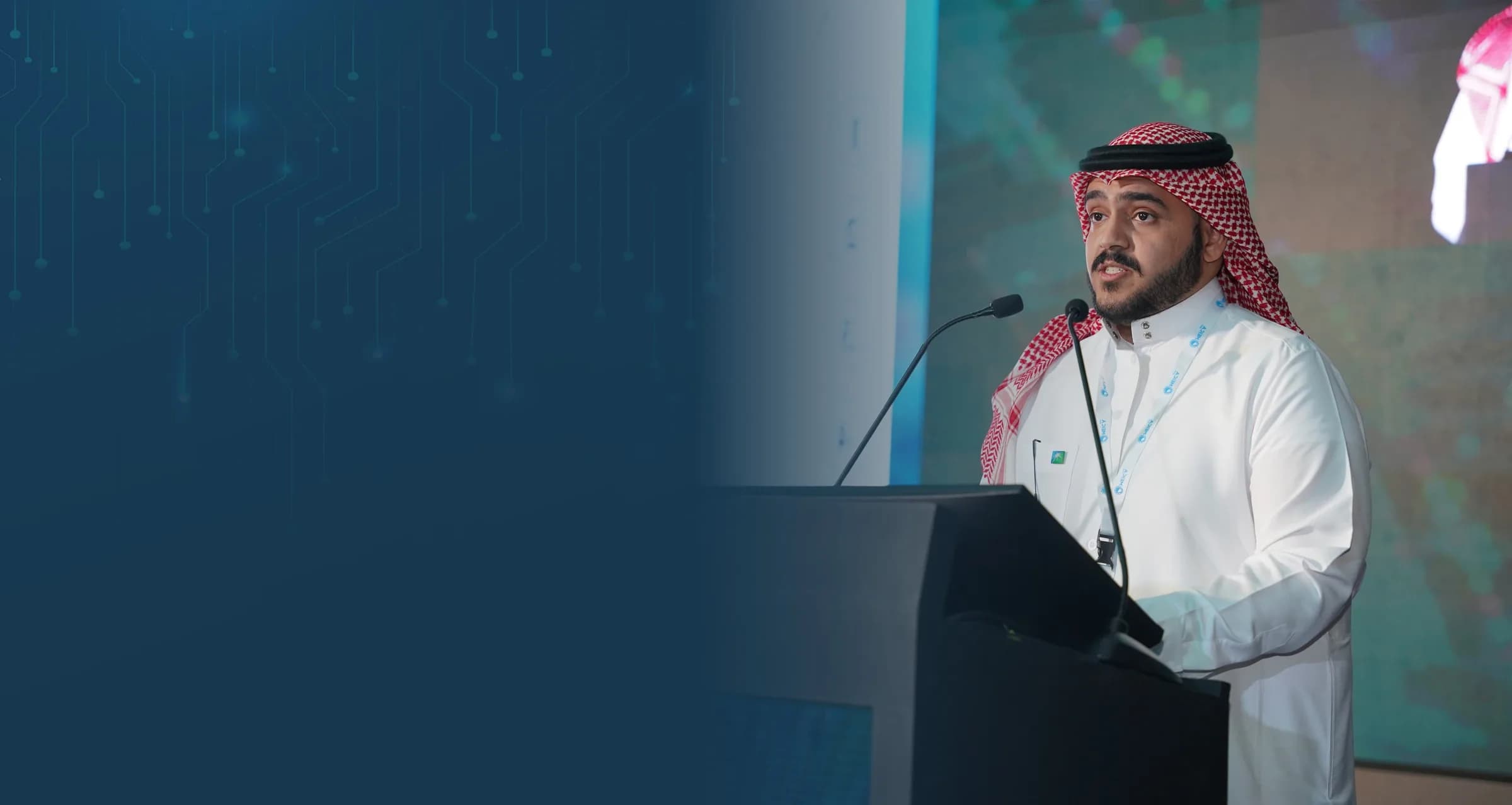 A speaker presenting a technical paper at the podium
