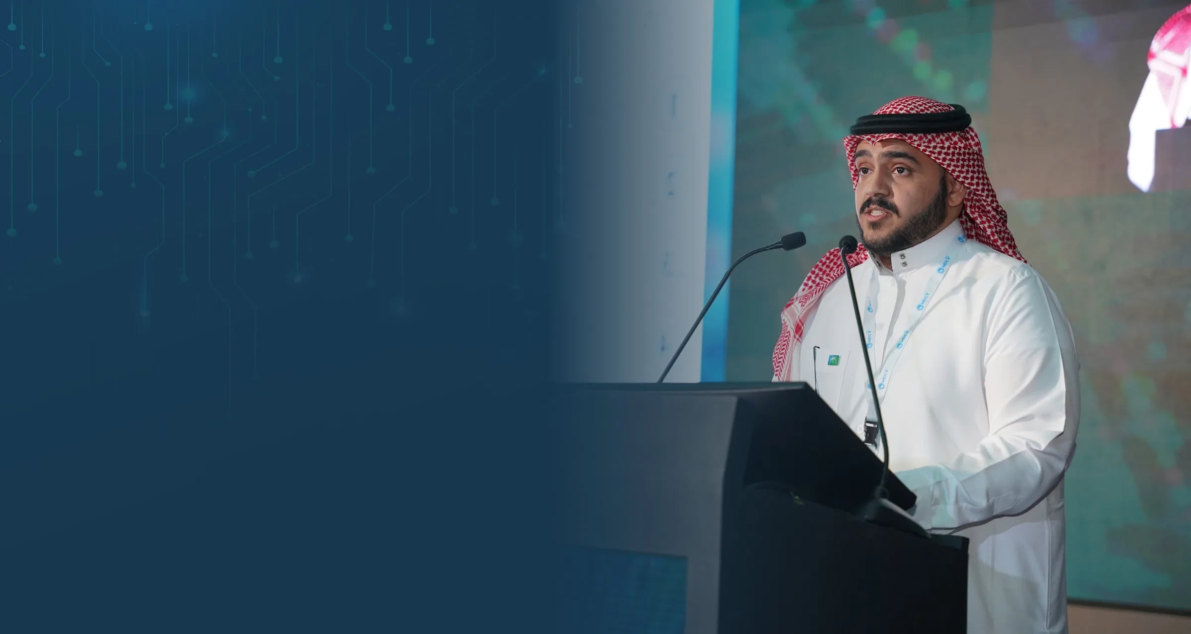 A speaker presenting a technical paper at the MEICA Expo podium